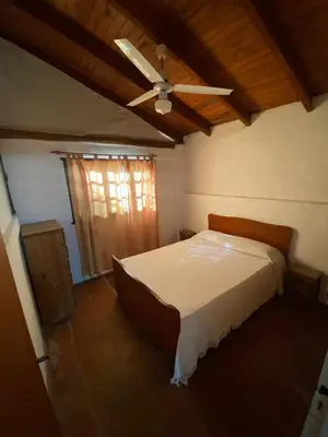 a bedroom with a bed and a ceiling fan at Abuelo Ramón in Mina Clavero