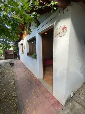 a white building with a sign on the side of it at Abuelo Ramón in Mina Clavero