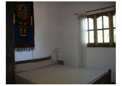 a bedroom with a bed and a window at Abuelo Ramón in Mina Clavero