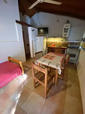 a kitchen with a table and chairs and a stove at Abuelo Ramón in Mina Clavero