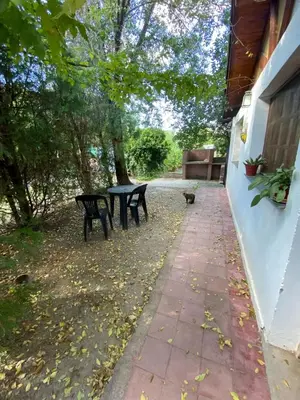 a patio with two benches and a table at Abuelo Ramón in Mina Clavero