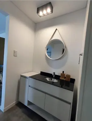 a bathroom with a sink and a mirror on the wall at Sam Lake SL in Villa Carlos Paz