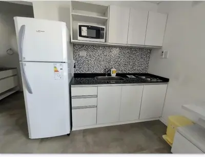 a kitchen with a white refrigerator and a microwave at Sam Lake SL in Villa Carlos Paz