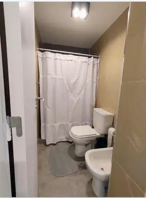 a bathroom with a toilet and a sink at Sam Lake SL in Villa Carlos Paz