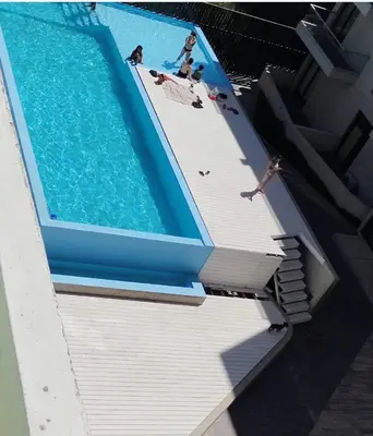 a swimming pool with people playing in the water at Sam Lake SL in Villa Carlos Paz