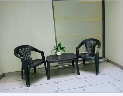 two chairs and a table with a potted plant at Sam Lake SL in Villa Carlos Paz