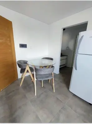 a kitchen with a table and two chairs and a refrigerator at Sam Lake SL in Villa Carlos Paz