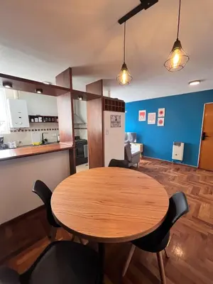 a dining room with a wooden table and chairs at Departamento moderno para 3 personas en Zona Nueva Córdoba in Cordoba
