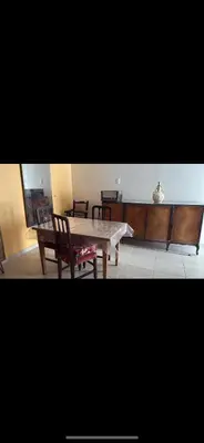 a dining room with a wooden table and a bench at Departamento monoambiente in Villa Carlos Paz