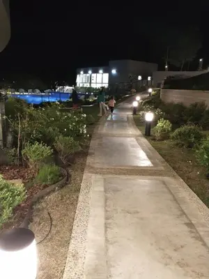 a walkway at night with people walking down it at Veneto Village in Villa Parque Siquiman