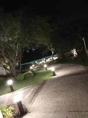 a park at night with lights on the grass at Veneto Village in Villa Parque Siquiman