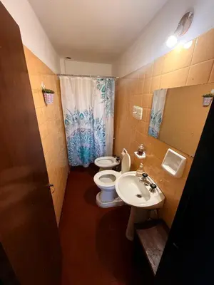 a bathroom with a toilet and a sink at Departamento El Fantasio in Villa Carlos Paz