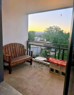 a bench sitting on a balcony with a view at El Nogal ll in Villa Carlos Paz