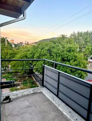 a view of a balcony with a fence and trees at El Nogal ll in Villa Carlos Paz