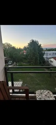 a balcony with a bench and a view of a field at El Nogal ll in Villa Carlos Paz