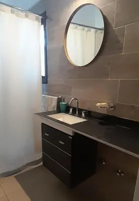 a bathroom with a sink and a mirror at Mirador Oeste Potrero de Garay in Potrero de Garay