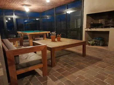 a living room with a ping pong table and a chair at Mirador Oeste Potrero de Garay in Potrero de Garay