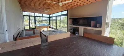 a large room with a table and some windows at Mirador Oeste Potrero de Garay in Potrero de Garay