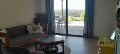 a living room with a couch and a glass table at Mirador Oeste Potrero de Garay in Potrero de Garay