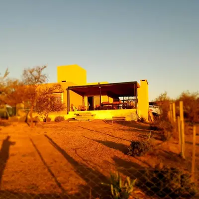 a yellow building in the middle of a field at Mirador Oeste Potrero de Garay in Potrero de Garay