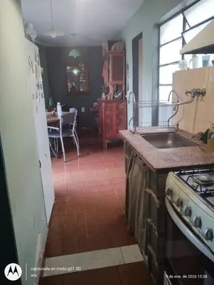 a kitchen with a sink and a stove top oven at 'Ña Emma in Cosquín