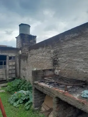 an old brick building with a stove in a yard at 'Ña Emma in Cosquín