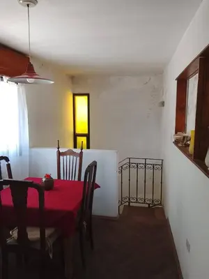 a dining room with a red table and chairs at Casita in Cordoba
