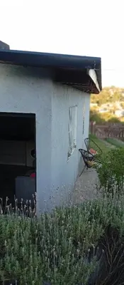 a building with a chair sitting outside of it at Casa Sol Naciente in Villa Santa Cruz del Lago