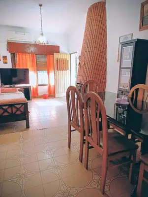 a living room with a dining room table and chairs at Casa Santa Rosa de Calamuchita in Santa Rosa de Calamuchita