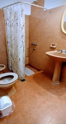 a bathroom with a shower and a toilet and a sink at Casa Santa Rosa de Calamuchita in Santa Rosa de Calamuchita