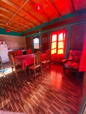 a dining room with a table and chairs and a couch at Alojamientos La Clarita in Arroyo de Los Patos