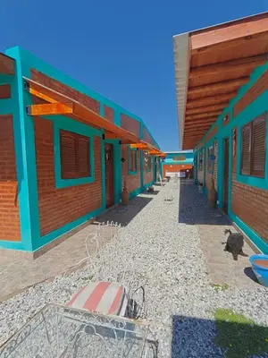 a row of colorful buildings on a beach at Alojamientos La Clarita in Arroyo de Los Patos