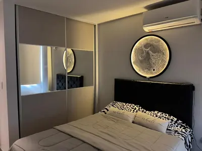 a bedroom with a bed and a large mirror at Calma Urbana in Cordoba