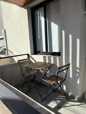 two chairs and a table on a balcony at Calma Urbana in Cordoba