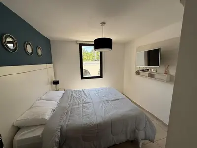 a bedroom with a bed and a window and a tv at Departamento Jacinto en Córdoba in Cordoba