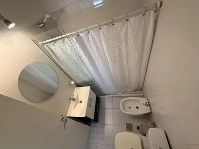 a small bathroom with a toilet and a mirror at Departamento Jacinto en Córdoba in Cordoba