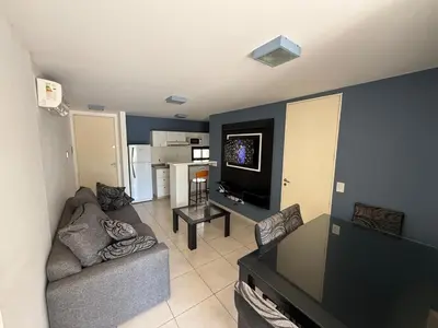 a living room with a couch and a tv at Departamento Jacinto en Córdoba in Cordoba