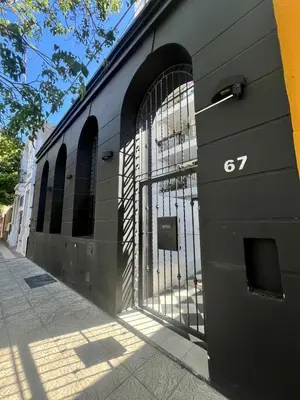 a black building with a gate on the side of it at Departamento Jacinto en Córdoba in Cordoba