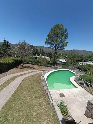 a small green swimming pool in a yard at Bendecida in San Antonio de Arredondo