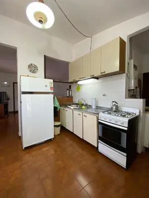 a kitchen with a stove and a white refrigerator at Bendecida in San Antonio de Arredondo