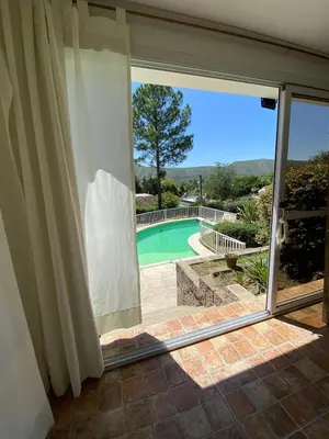 a sliding glass door with a view of a swimming pool at Bendecida in San Antonio de Arredondo