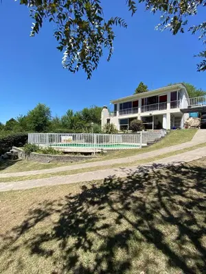 a building with a white fence in front of it at Bendecida in San Antonio de Arredondo