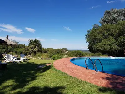 a swimming pool in the yard of a house at Hostal La Quebrada in Cortaderas