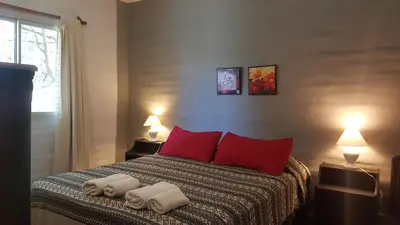 a bedroom with a bed with two towels on it at Hostal La Quebrada in Cortaderas