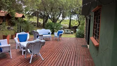 a group of chairs and tables on a patio at Hostal La Quebrada in Cortaderas