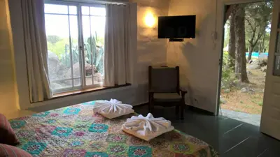 a bedroom with a bed with two towels on it at Hostal La Quebrada in Cortaderas