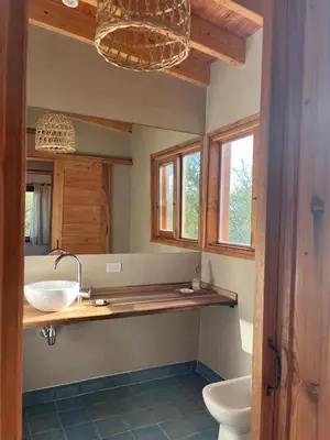 a bathroom with two sinks and a toilet and windows at Casa Estudio Japandi in San Javier