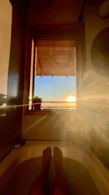 a person standing in a bath tub looking out a window at Casa Estudio Japandi in San Javier