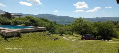 a red van parked next to a swimming pool at Pacha Samay in Villa Parque Siquiman