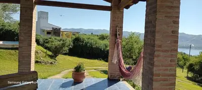 a porch with a hammock and a view at Pacha Samay in Villa Parque Siquiman
